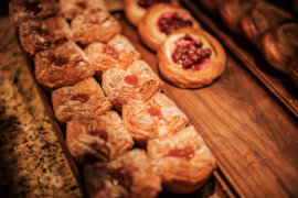 Assorted pastries in a display case at Halekulani Bakery